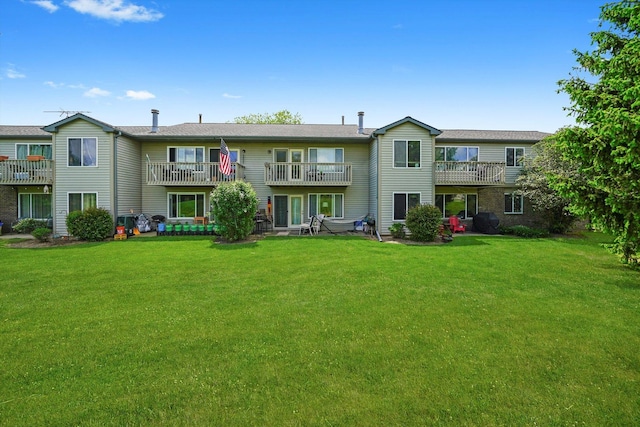 240 Crestview Dr Unit B, Wauconda, IL 60084 - rear view of property featuring a balcony and a lawn