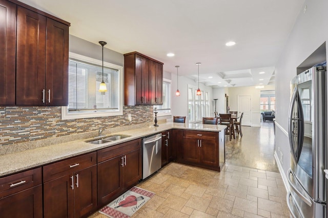 8120 S Luella Ave, Chicago, IL 60617 - kitchen featuring stainless steel appliances, a peninsula, tasteful backsplash, hanging light fixtures, and recessed lighting