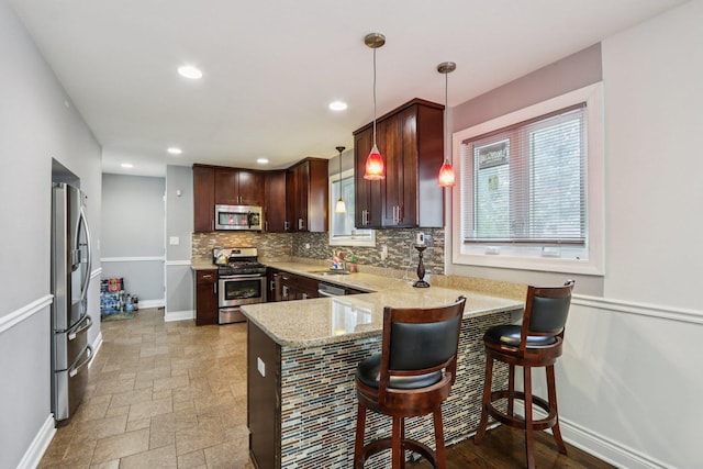 8120 S Luella Ave, Chicago, IL 60617 - kitchen with appliances with stainless steel finishes, a peninsula, decorative backsplash, recessed lighting, and dark brown cabinets