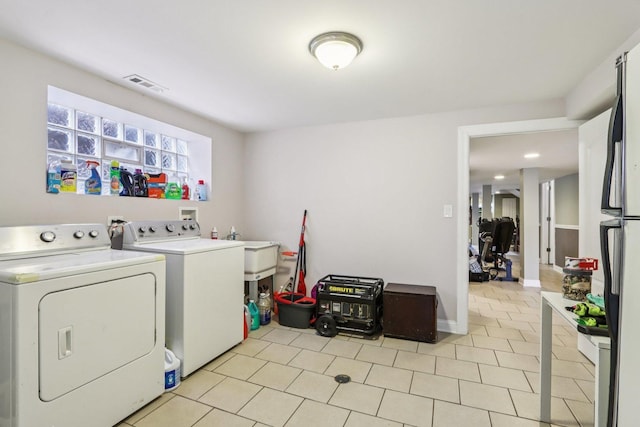 8120 S Luella Ave, Chicago, IL 60617 - laundry room featuring washing machine and clothes dryer and light tile patterned floors