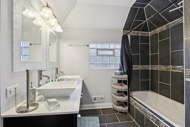 8120 S Luella Ave, Chicago, IL 60617 - bathroom featuring tile patterned flooring, double vanity, tiled shower / bath, and vaulted ceiling