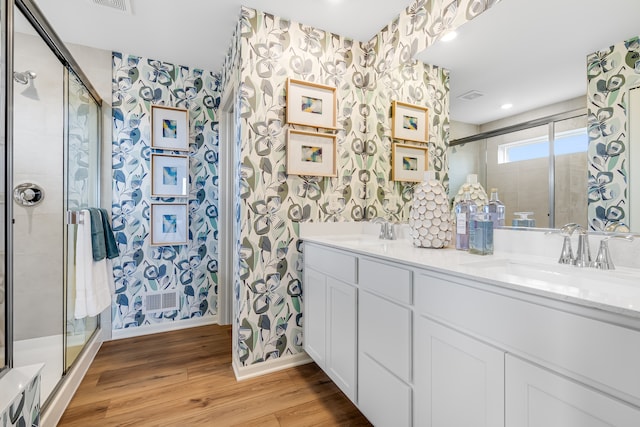 529 S Kincaid St, Maple Park, IL 60151 - bathroom featuring wallpapered walls, wood finished floors, a shower stall, and double vanity