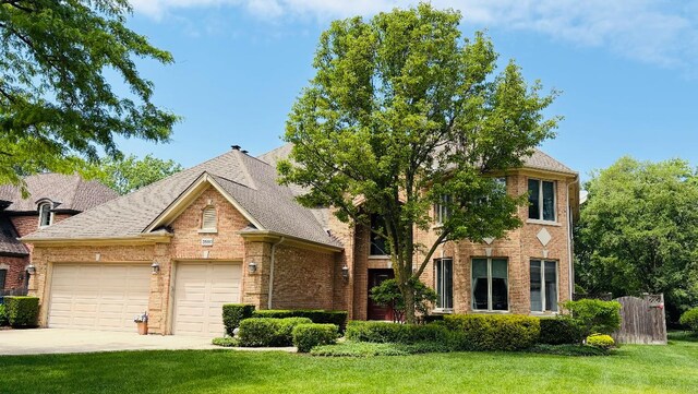 3550 Sorrel Dr, Northbrook, IL 60062 - view of front facade featuring a garage, brick siding, driveway, and a shingled roof