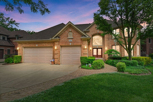 3550 Sorrel Dr, Northbrook, IL 60062 - view of front of property featuring concrete driveway, an attached garage, brick siding, and a yard