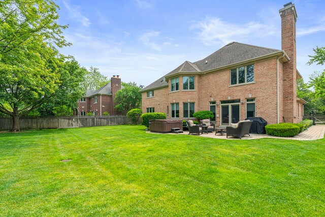 3550 Sorrel Dr, Northbrook, IL 60062 - rear view of house featuring a hot tub, a fenced backyard, a patio, a chimney, and brick siding
