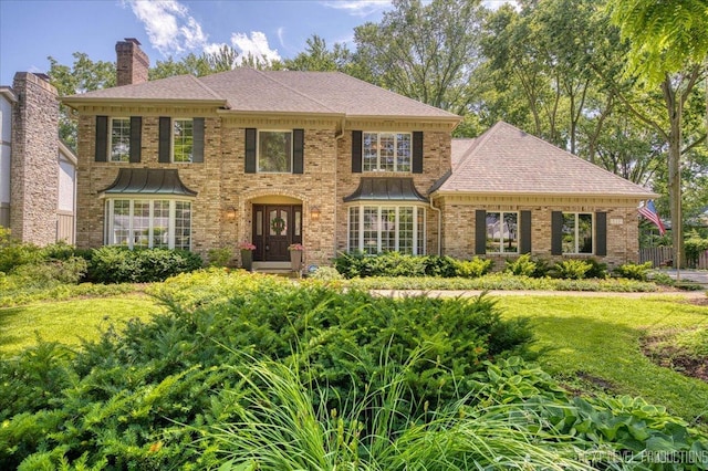 1412 Sherwood Ln, Geneva, IL 60134 - colonial house featuring a chimney, brick siding, a shingled roof, and a front yard