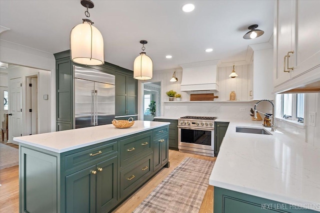 1412 Sherwood Ln, Geneva, IL 60134 - kitchen featuring green cabinets, high end appliances, custom exhaust hood, decorative light fixtures, and light wood-style flooring