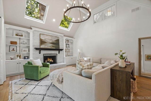 1412 Sherwood Ln, Geneva, IL 60134 - living room featuring high vaulted ceiling, a fireplace, wood finished floors, built in features, and a chandelier
