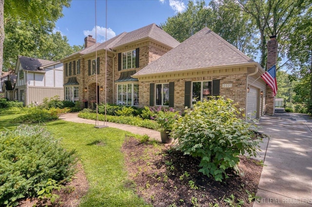 1412 Sherwood Ln, Geneva, IL 60134 - view of front of house featuring a chimney, brick siding, asphalt driveway, and an attached garage