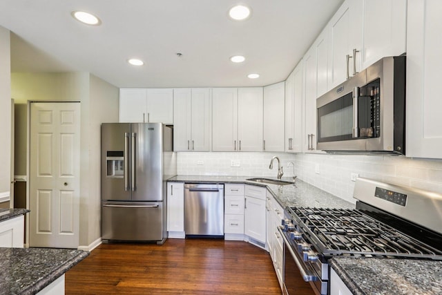 454 Blue Springs Dr, Fox Lake, IL 60020 - kitchen with stainless steel appliances, dark stone counters, white cabinetry, backsplash, and recessed lighting