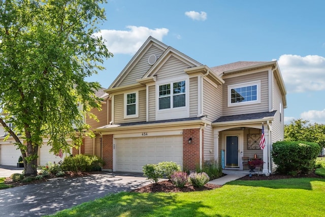 454 Blue Springs Dr, Fox Lake, IL 60020 - view of front of property featuring driveway, a front lawn, an attached garage, and brick siding