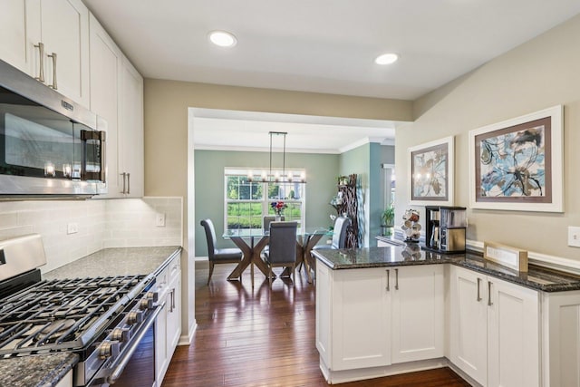 454 Blue Springs Dr, Fox Lake, IL 60020 - kitchen with stainless steel appliances, dark stone counters, dark wood-style flooring, white cabinetry, and tasteful backsplash