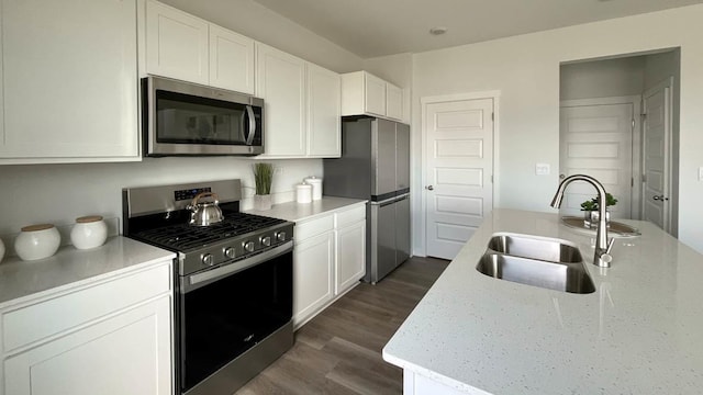 998 Amethyst Ln, Montgomery, IL 60538 - kitchen featuring appliances with stainless steel finishes, dark wood finished floors, white cabinets, and light stone countertops