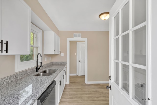 2059 Downey Rd, Homewood, IL 60430 - kitchen with stainless steel dishwasher, white cabinets, light wood-style flooring, and light stone counters