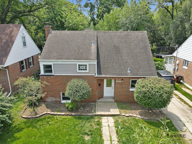 2059 Downey Rd, Homewood, IL 60430 - view of front of property featuring brick siding, a trampoline, roof with shingles, and a chimney