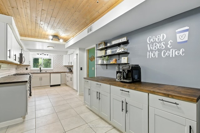 204 Wood St, Wilmington, IL 60481 - kitchen with butcher block counters, dishwasher, wood ceiling, light tile patterned flooring, and tasteful backsplash