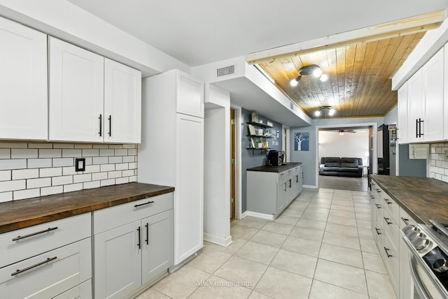 204 Wood St, Wilmington, IL 60481 - kitchen featuring butcher block countertops, stainless steel range, wood ceiling, decorative backsplash, and light tile patterned floors