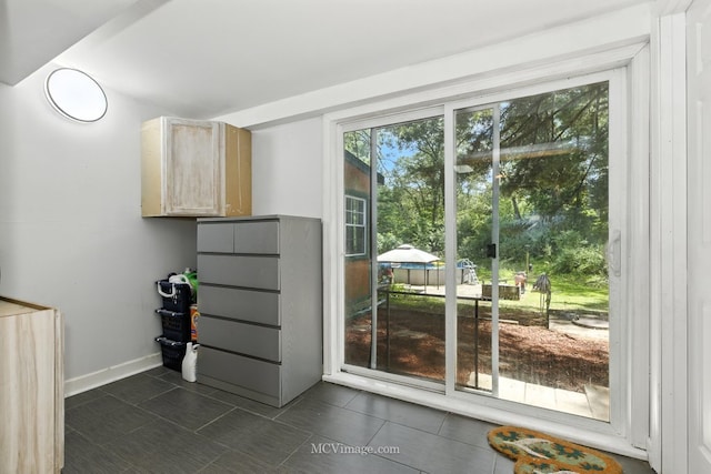 204 Wood St, Wilmington, IL 60481 - doorway to outside with dark tile patterned floors and baseboards