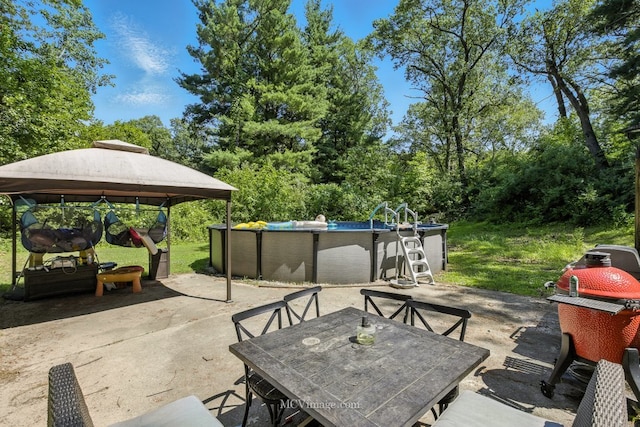 204 Wood St, Wilmington, IL 60481 - view of patio / terrace with outdoor dining space, a gazebo, and an outdoor pool