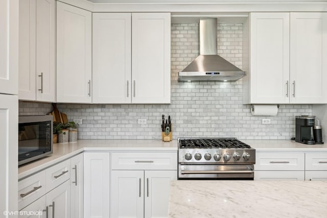 161 N Schubert St, Palatine, IL 60067 - kitchen with wall chimney exhaust hood, appliances with stainless steel finishes, decorative backsplash, and white cabinets