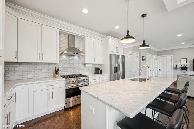 161 N Schubert St, Palatine, IL 60067 - kitchen with appliances with stainless steel finishes, wall chimney range hood, crown molding, dark wood-type flooring, and a breakfast bar area