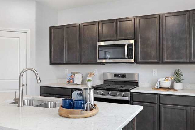994 Amethyst Ln, Montgomery, IL 60538 - kitchen featuring stainless steel appliances, dark brown cabinets, and light stone countertops
