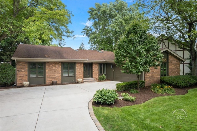1105 W Bauer Rd, Naperville, IL 60563 - view of front of house with concrete driveway, brick siding, a shingled roof, and a garage