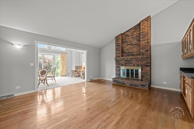 1105 W Bauer Rd, Naperville, IL 60563 - unfurnished living room with wood finished floors, high vaulted ceiling, and a fireplace