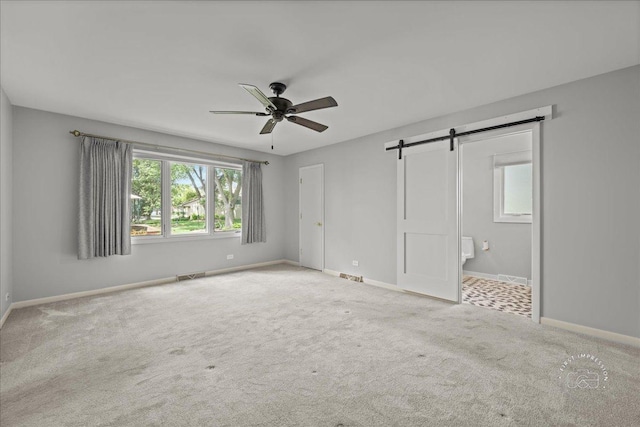 1105 W Bauer Rd, Naperville, IL 60563 - unfurnished bedroom with a barn door, carpet, ensuite bath, and a ceiling fan