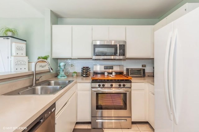 2261 Petworth Ct Unit 201C, Naperville, IL 60565 - kitchen featuring appliances with stainless steel finishes, light countertops, white cabinets, and light tile patterned flooring