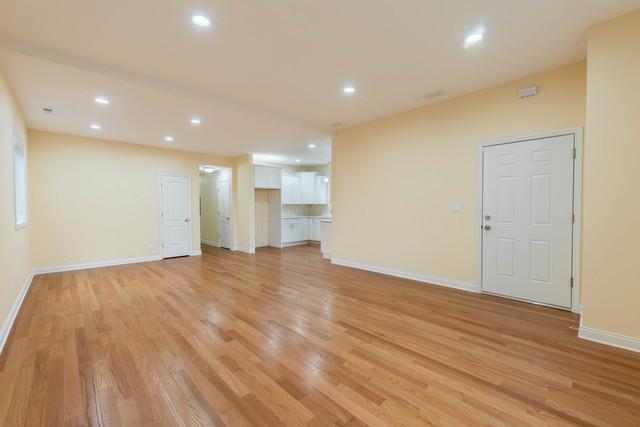5326 W 31st St, Cicero, IL 60804 - unfurnished living room with light wood finished floors and recessed lighting