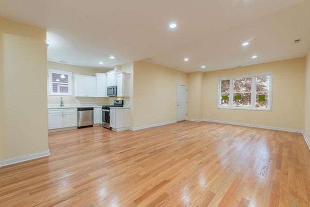 5326 W 31st St, Cicero, IL 60804 - unfurnished living room with light wood-type flooring and recessed lighting