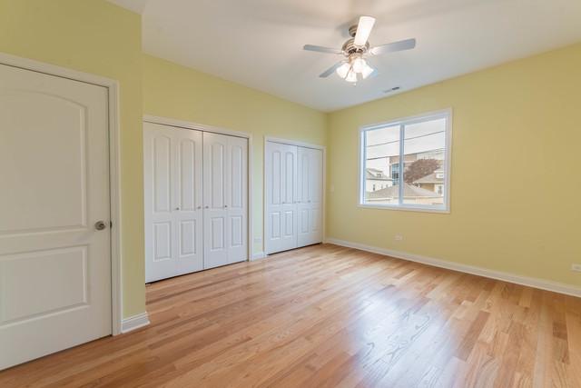 5326 W 31st St, Cicero, IL 60804 - unfurnished bedroom featuring two closets, light wood-type flooring, and ceiling fan