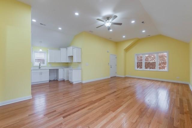 5326 W 31st St, Cicero, IL 60804 - unfurnished living room with vaulted ceiling, a ceiling fan, light wood-type flooring, and recessed lighting
