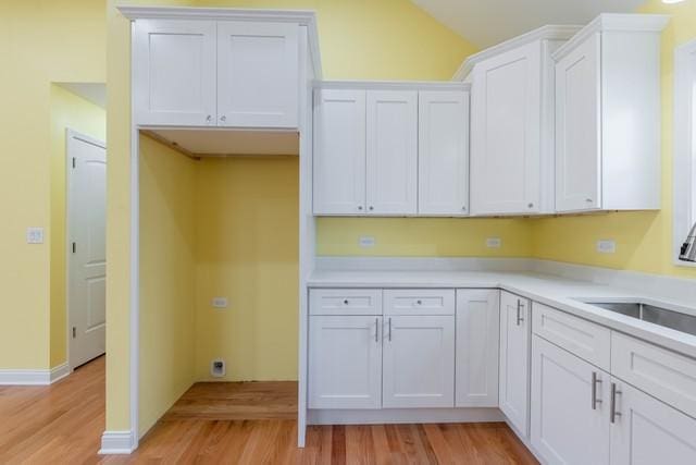 5326 W 31st St, Cicero, IL 60804 - kitchen featuring light wood finished floors, white cabinetry, vaulted ceiling, and light countertops