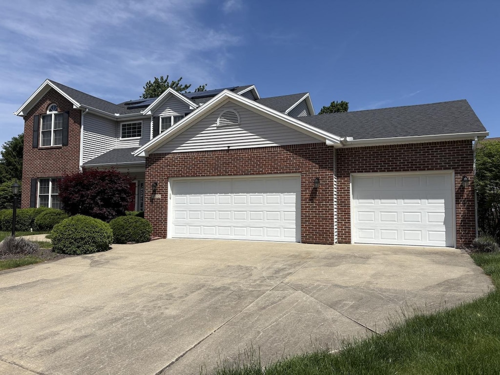 4502 Graves Ct, Champaign, IL 61822 - traditional-style house featuring an attached garage, driveway, and brick siding