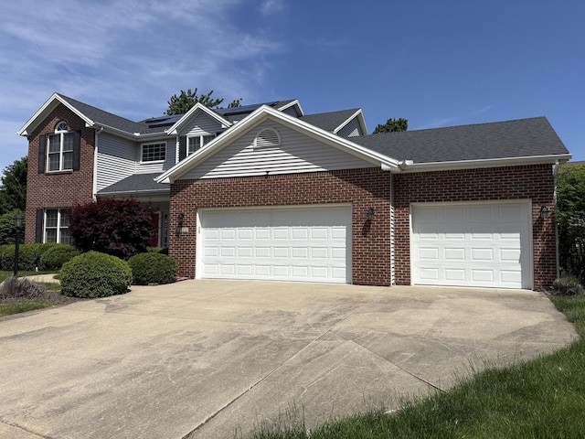 4502 Graves Ct, Champaign, IL 61822 - traditional-style house featuring an attached garage, driveway, and brick siding