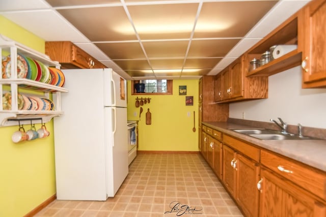 712 Hauert St, Peotone, IL 60468 - kitchen featuring freestanding refrigerator, brown cabinetry, stove, and light floors