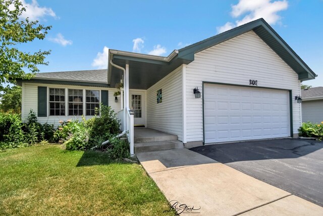 712 Hauert St, Peotone, IL 60468 - ranch-style home with an attached garage, a front yard, and asphalt driveway
