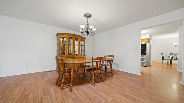 5715 Elaine Dr, Rockford, IL 61108 - dining area with light wood-style floors and a chandelier