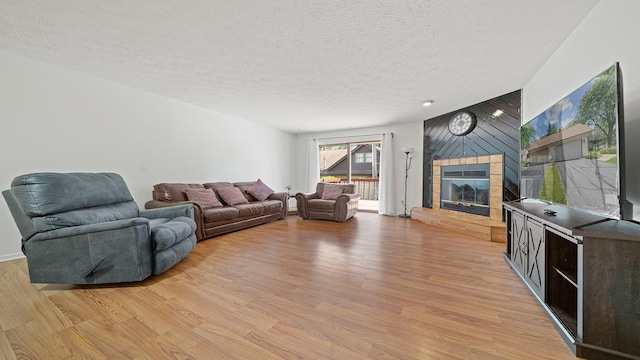 5715 Elaine Dr, Rockford, IL 61108 - living room featuring a fireplace, light wood finished floors, and a textured ceiling