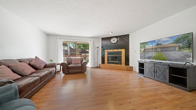 5715 Elaine Dr, Rockford, IL 61108 - living area featuring a textured ceiling, light wood-style floors, and a fireplace