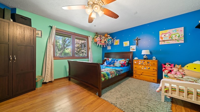 5715 Elaine Dr, Rockford, IL 61108 - bedroom with wood finished floors, ceiling fan, and a textured ceiling
