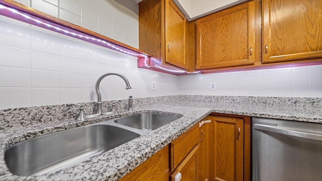 5715 Elaine Dr, Rockford, IL 61108 - kitchen with stainless steel dishwasher, tasteful backsplash, brown cabinets, and light stone counters