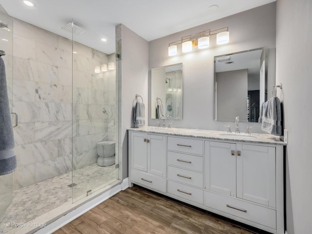 1401 Burr Oak Rd Unit 312B, Hinsdale, IL 60521 - bathroom featuring a shower stall, double vanity, wood finished floors, and recessed lighting