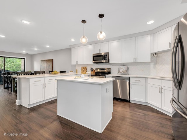 1401 Burr Oak Rd Unit 312B, Hinsdale, IL 60521 - kitchen featuring appliances with stainless steel finishes, a peninsula, light countertops, white cabinets, and recessed lighting