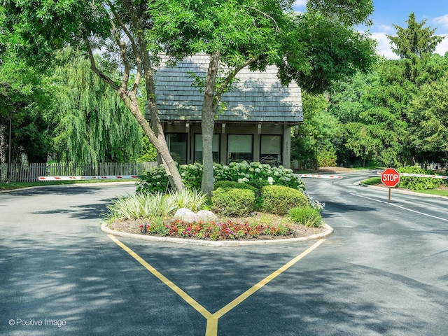1401 Burr Oak Rd Unit 312B, Hinsdale, IL 60521 - view of asphalt road featuring traffic signs and curbs