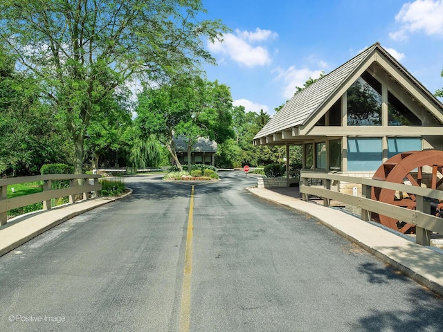 1401 Burr Oak Rd Unit 312B, Hinsdale, IL 60521 - view of asphalt street with traffic signs, curbs, and view of scattered trees