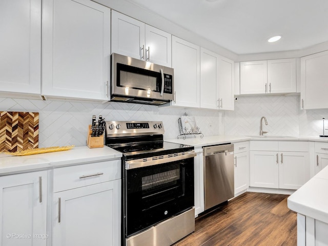 1401 Burr Oak Rd Unit 312B, Hinsdale, IL 60521 - kitchen featuring appliances with stainless steel finishes, white cabinetry, light countertops, decorative backsplash, and dark wood-style floors