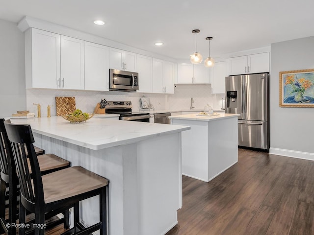 1401 Burr Oak Rd Unit 312B, Hinsdale, IL 60521 - kitchen featuring stainless steel appliances, a peninsula, decorative backsplash, white cabinetry, and recessed lighting